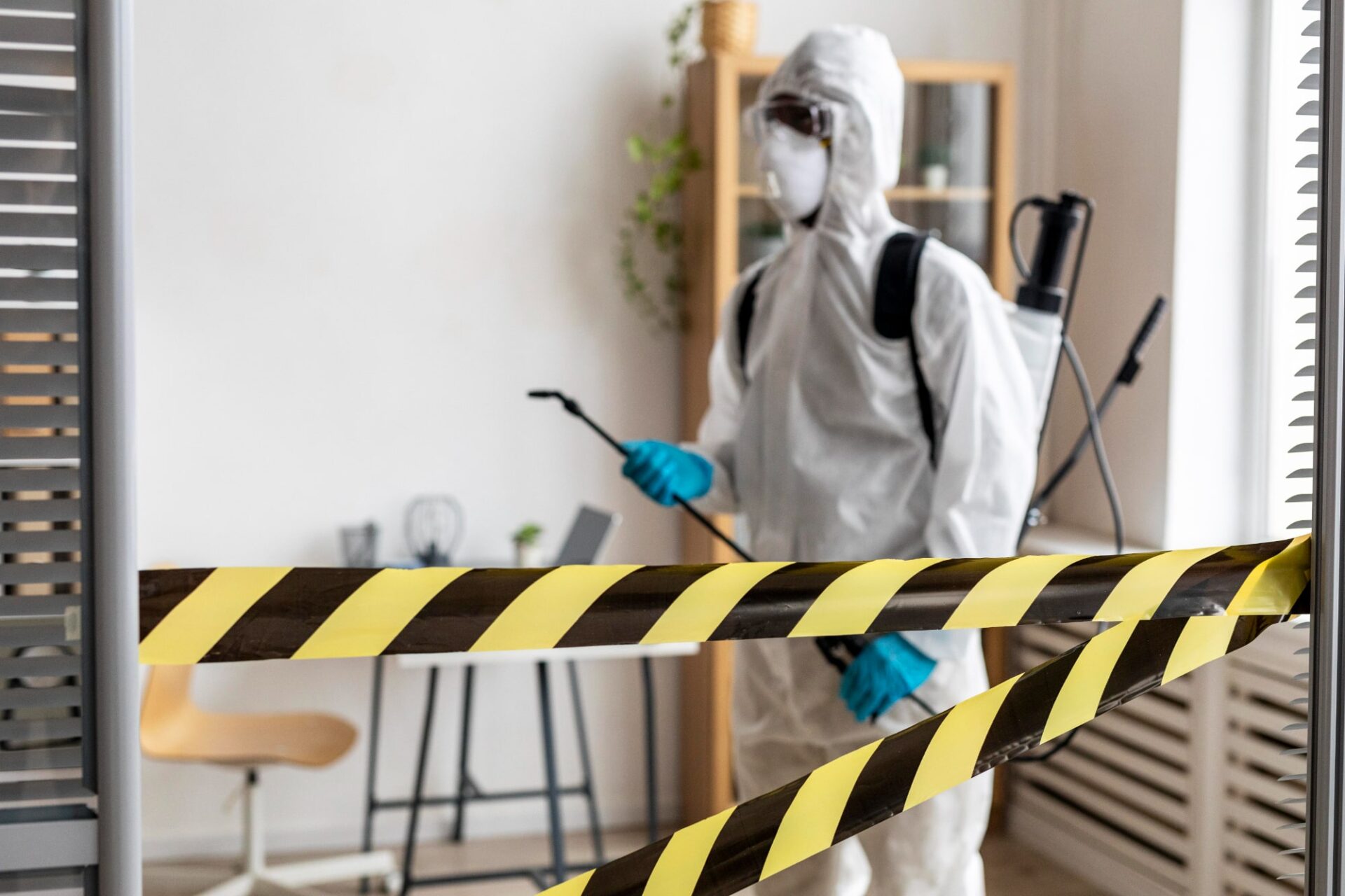 Worker in hazmat suits managing asbestos materials at a recycling facility, emphasizing the importance of asbestos testing and removalist services.