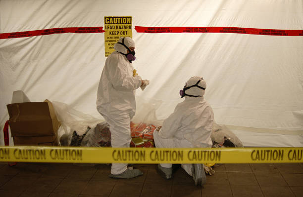 Workers in hazmat suits preparing for asbestos testing and safe removal services in hazardous environments.